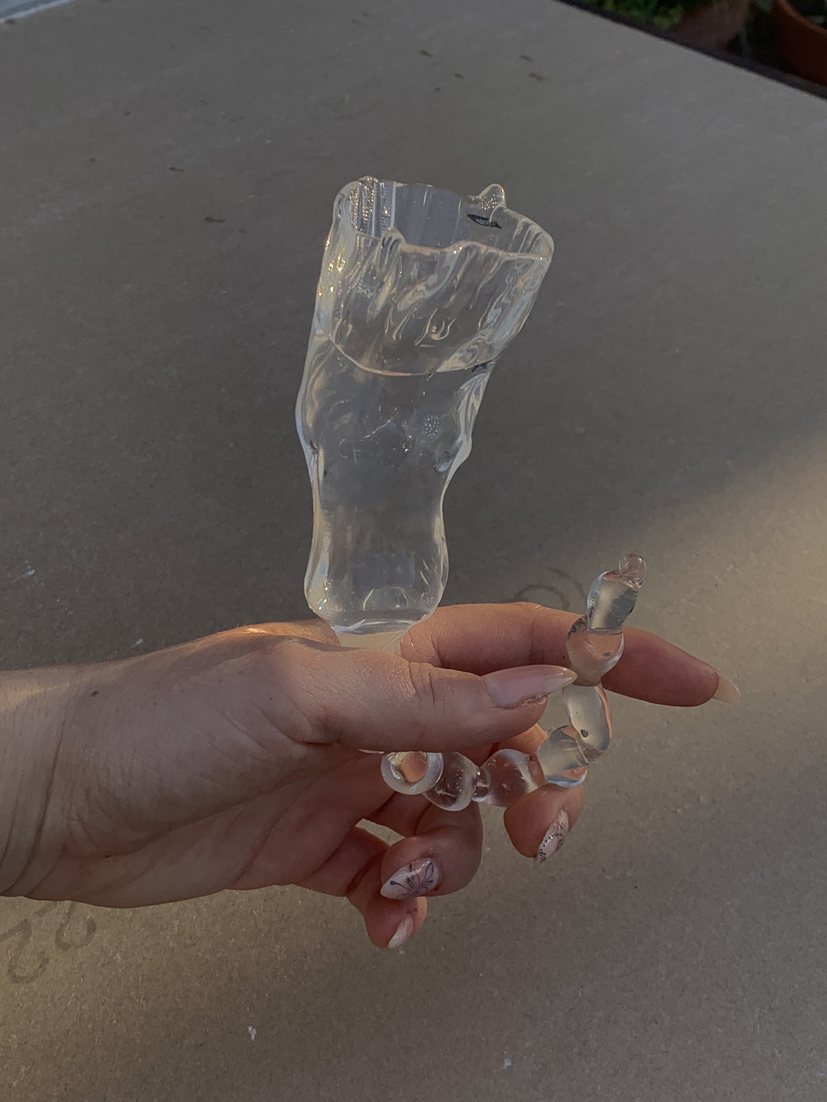 Glasses 0007 in clear hand-sculpted borosilicate glass, held in the hand, Rain and Rivers, Barcelona
