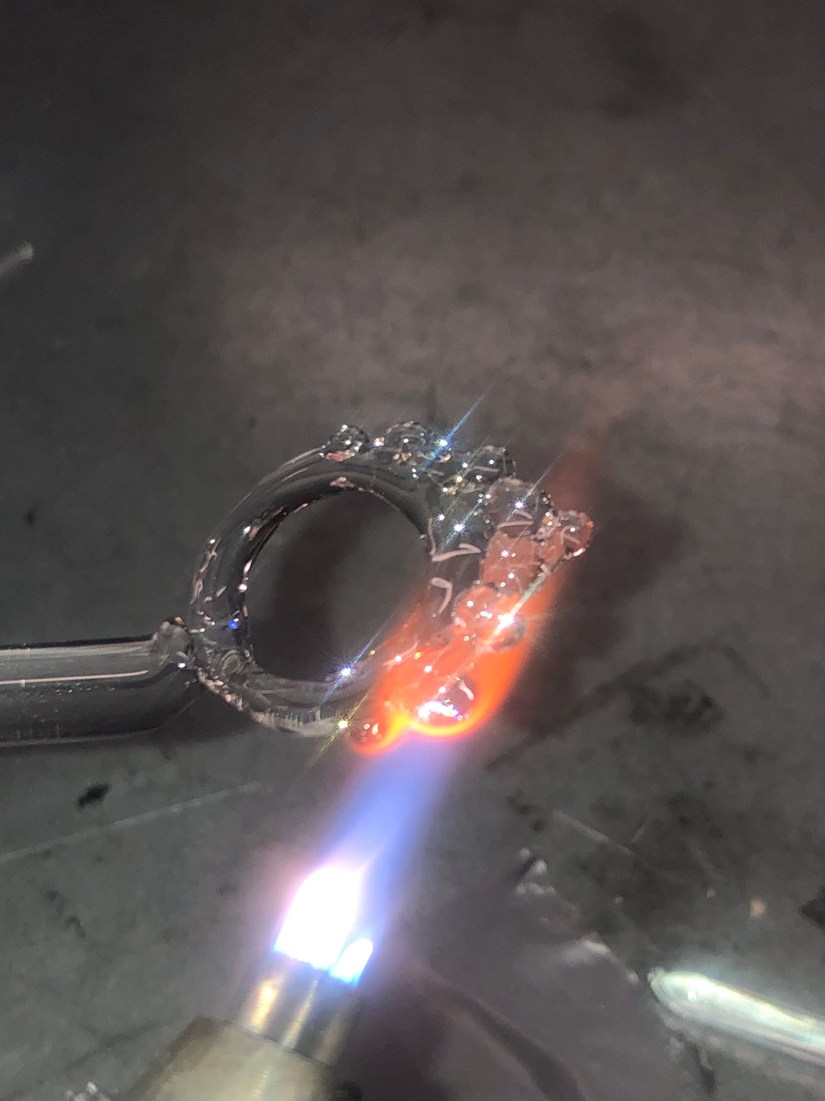 Glass ring being formed at the flame in the Rain and Rivers studio in Barcelona, hand-sculpted borosilicate glass