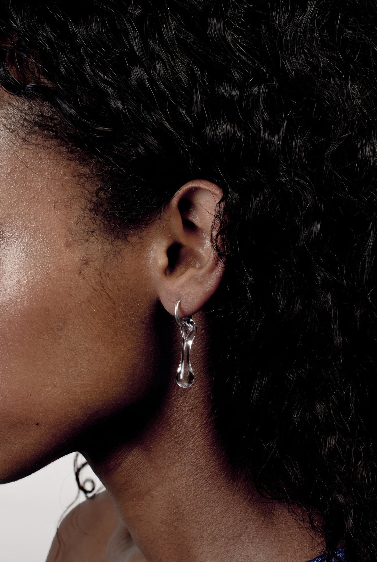 Mini Hoop Earrings 0012 in clear hand-sculpted borosilicate glass, worn on the ear, Rain and Rivers