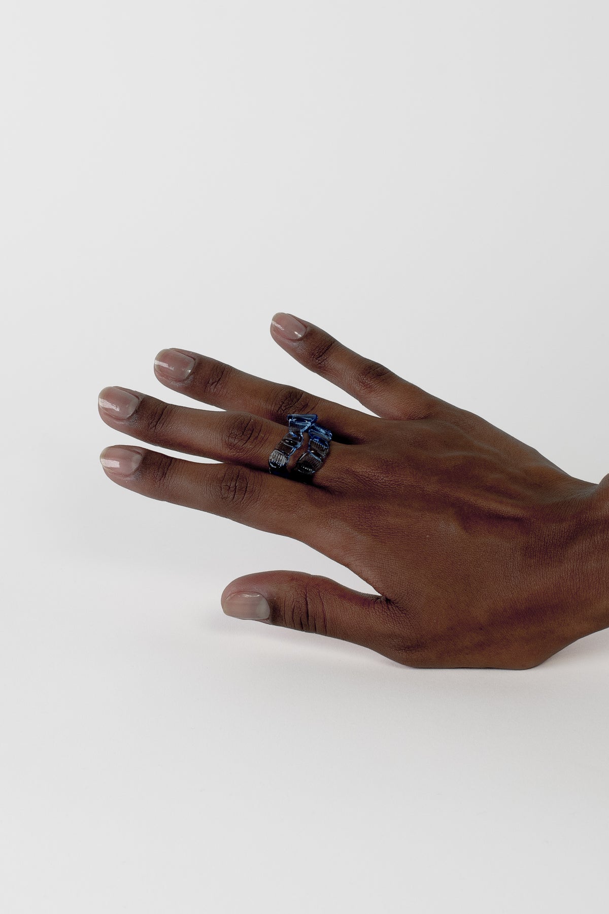 Textured Stacking Glass Rings 0124 in sky blue worn layered on the hand, hand-sculpted borosilicate glass by Rain and Rivers, Barcelona
