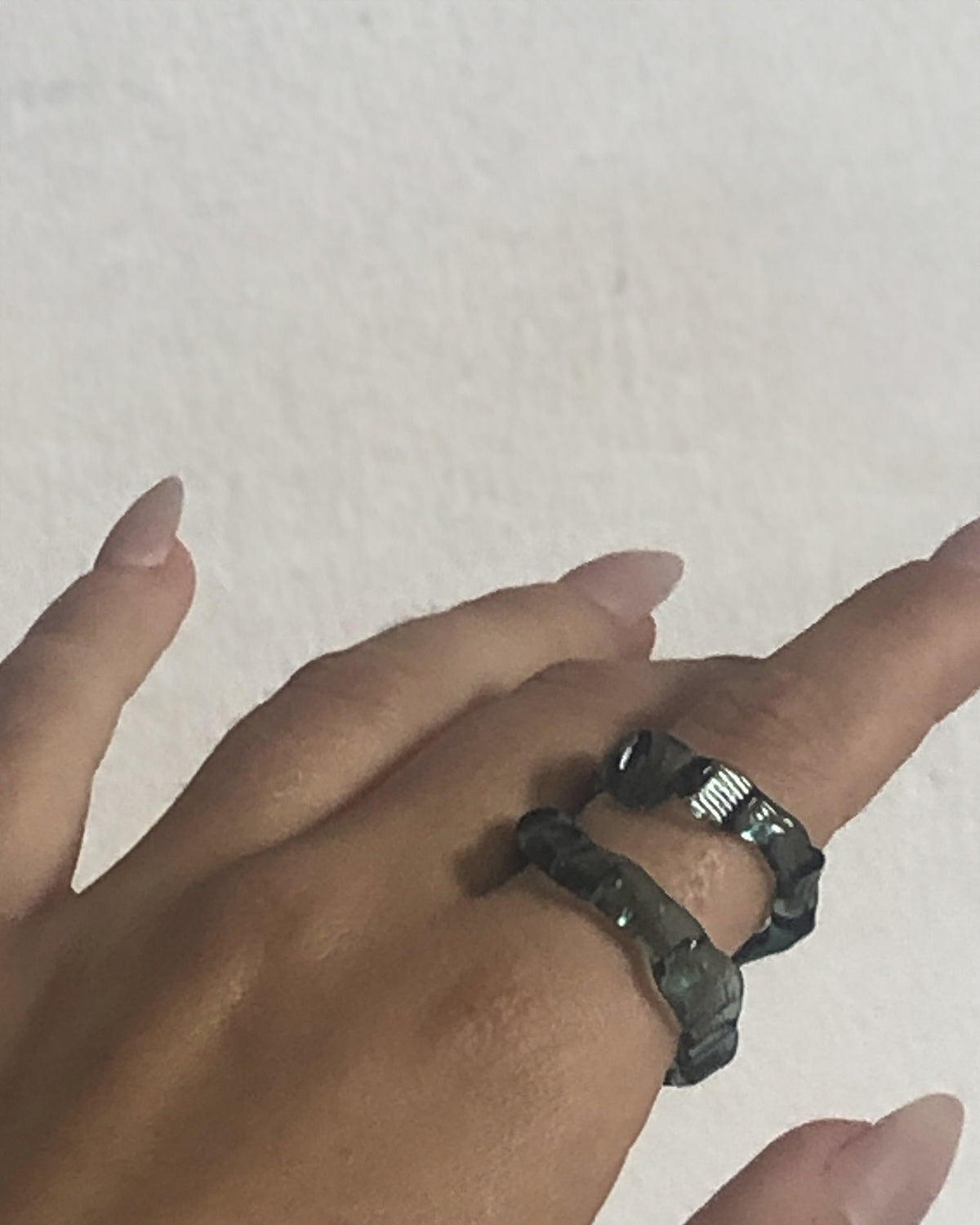 Textured Stacking Glass Rings 0124 in teal hand-sculpted borosilicate glass, worn on the hand, Rain and Rivers