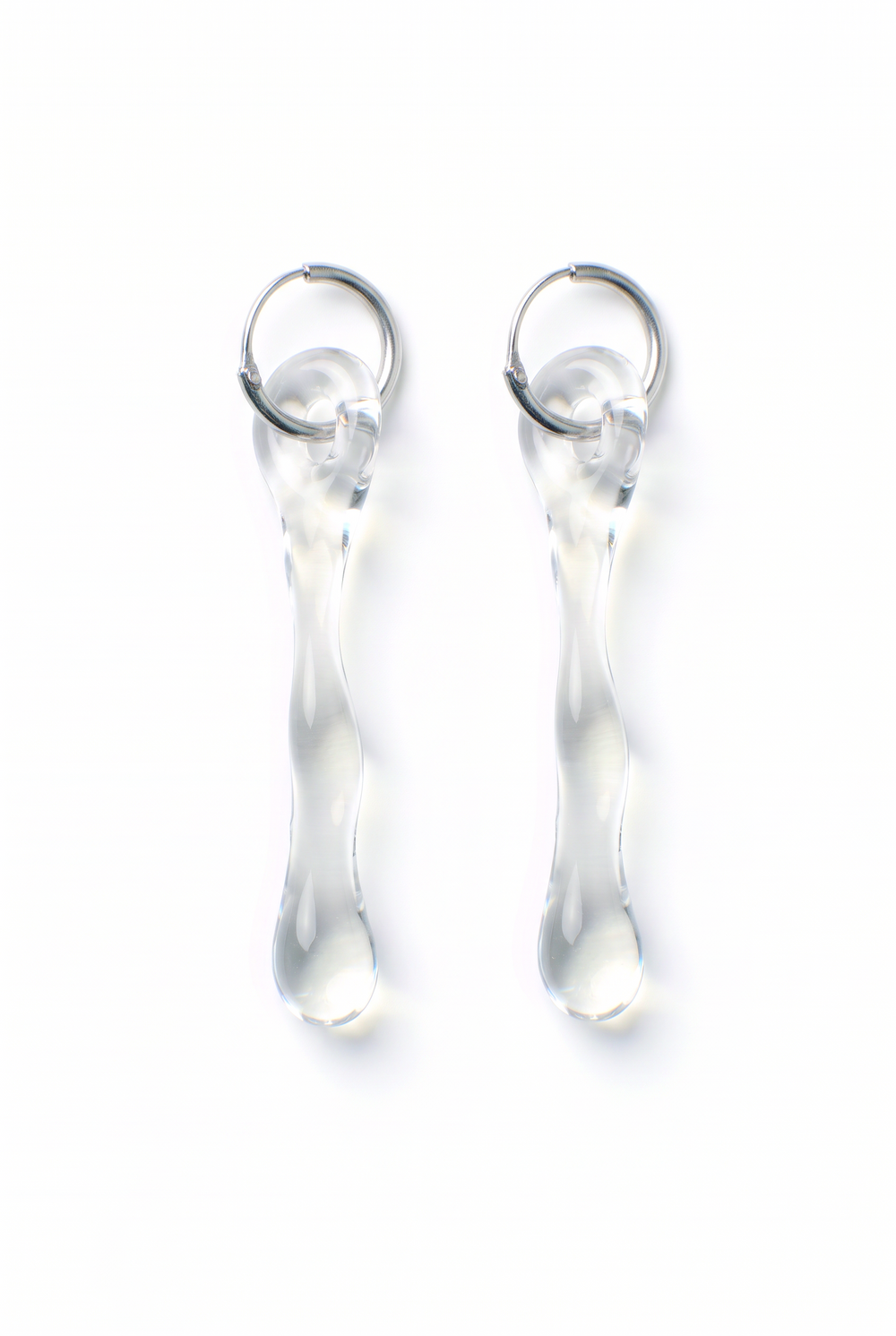Rain and Rivers Hoop Earrings 0010 – pair of hand-sculpted clear borosilicate glass drop earrings on steel hoops, handmade in Barcelona, product photo on white