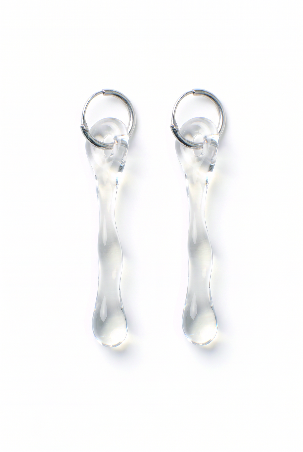 Rain and Rivers Hoop Earrings 0010 – pair of hand-sculpted clear borosilicate glass drop earrings on steel hoops, handmade in Barcelona, product photo on white