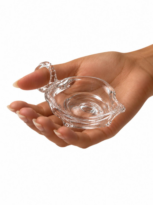 Ashtray 0001 by Rain and Rivers: a wearable handmade clear glass ashtray with a glass ring fused to its rim, worn on the finger while the dish rests in the palm, on a white background