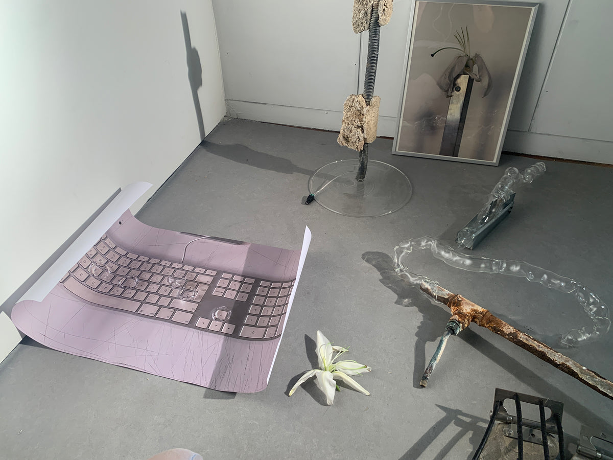 Magdalena Hart glass studio: blown glass pieces, tools and a keyboard on pink fabric